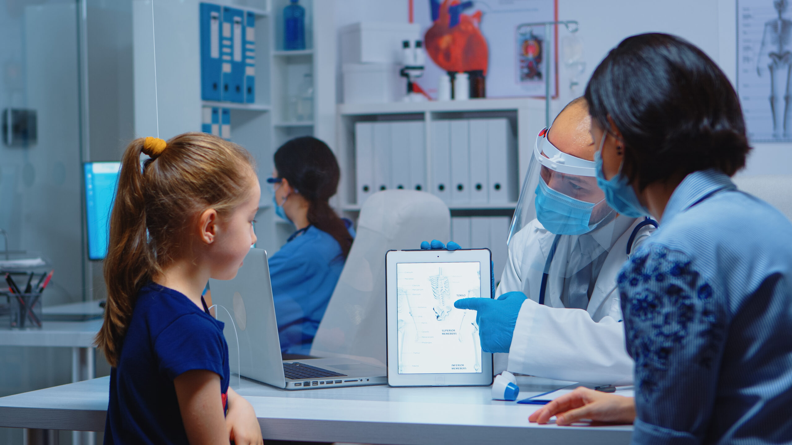Medical specialist presenting skeleton using tablet